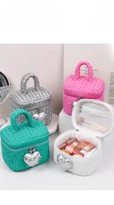 Detailed view of quilted makeup bags with heart charms and internal mesh compartments