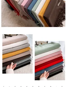Close-up detail of soft cashmere-feel scarves in various colors with fringe edges