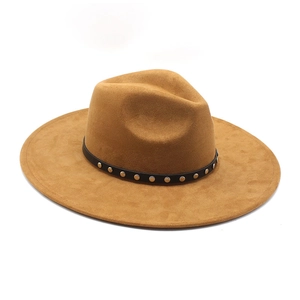 Detail of camel suede fedora hat featuring a black band with silver metal studs