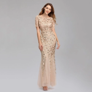 Detail of champagne gold sequins in elegant leaf patterns on mesh mermaid evening dress