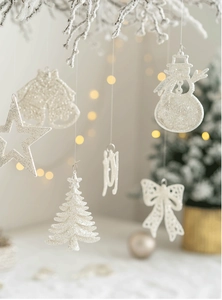 Set of white glitter Christmas ornaments including stars, trees, and joy letters