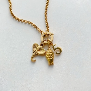 Detail view of a 14K gold-plated stainless steel DIY necklace with animal charms
