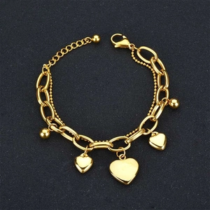 Detail of a double-layered gold heart bracelet with lobster clasp and adjustable chain