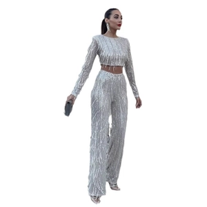 Sparkly silver sequin two-piece set featuring long sleeve crop top and wide leg pants