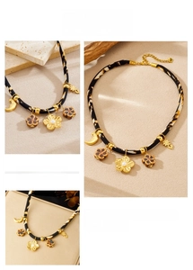 Detail of leopard print fabric choker with golden floral pendants and crescent moon charms