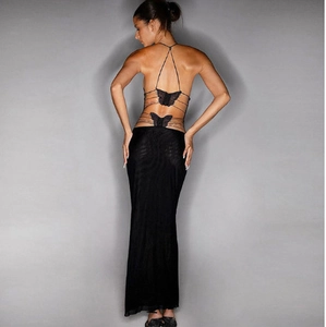 Detail of cross-straps on back with black butterfly lace appliques on sheer maxi dress