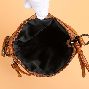 Brown lychee grain leather crossbody phone bag with zipper closure and tassel detail