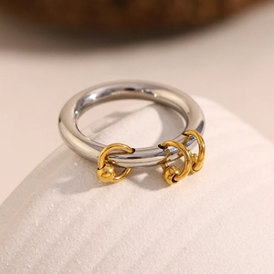 Detail of silver stainless steel ring featuring three hanging 18K gold bead charms