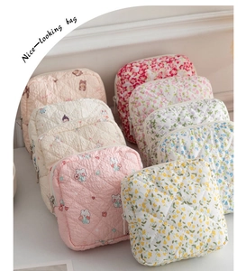 Detailed display of quilted cotton sanitary bags with floral and cartoon animal patterns