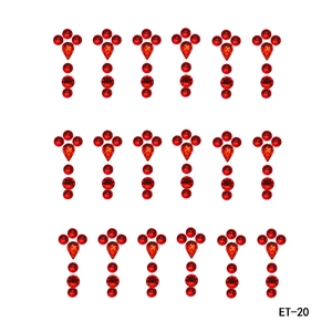 Detail view of ET-20 red rhinestone face jewels with teardrop and round diamond shapes