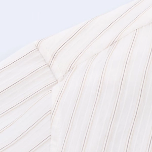 Detail showing high-quality stitching and light brown striped texture on white shirt