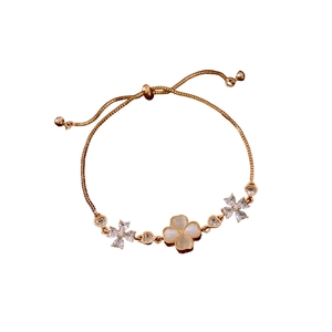 Adjustable gold plated clover bracelet with white cat-eye stone and crystal flowers