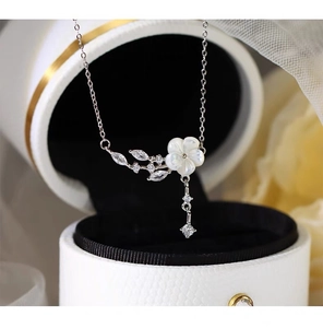 Detailed view of S925 silver flower pendant necklace with shimmering zircon tassels