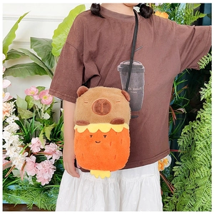 Detail of Capybara plush crossbody bag featuring strawberry design on child model