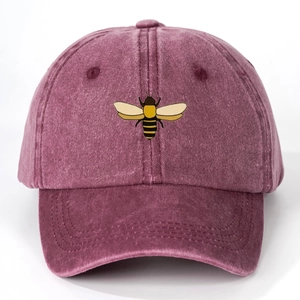 Detailed close-up of purple washed cotton baseball cap featuring embroidered bee pattern