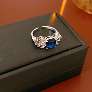 Détail d'une bague en argent en forme de feuille avec pierre bleue sur écrin
