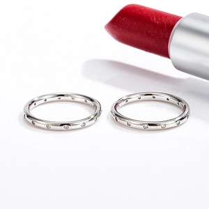 Elegant pair of silver S925 rings with sparkling round diamonds on a white background