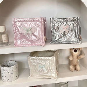 Three-piece quilted storage basket set with bow accents in pink, silver and beige colors