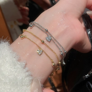 Detailed view of 18k gold plated double heart bracelets featuring sparkling cubic zirconia
