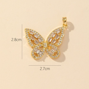 Detail showing 2.8cm gold butterfly pendant dimensions with cubic zirconia inlay