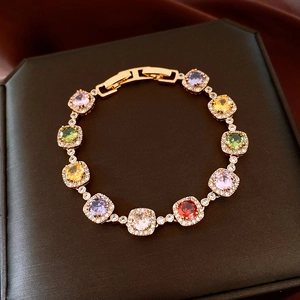 Macro shot of 18k gold plated bracelet with colorful square cut gemstones and pavé halo zircons