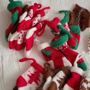 Close-up of handmade knitted Christmas mini stockings in festive red and green colors