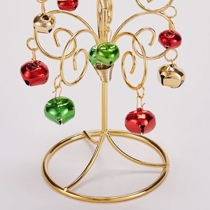 Mini metal wire Christmas tree with colorful bells and gold base on white background