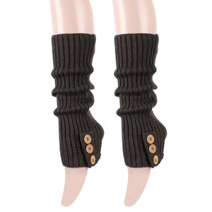Detailed knit texture of dark brown leg warmers with vintage wooden buttons and ribbed pattern