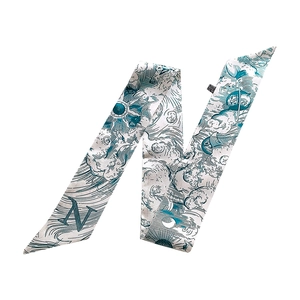 Detail of blue silk scarf featuring vintage celestial sun and moon prints and letter N