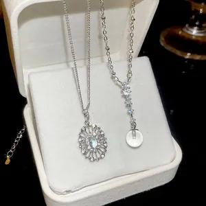 Elegant silver zircon oval pendant necklace set with blue gemstone in a white jewelry box