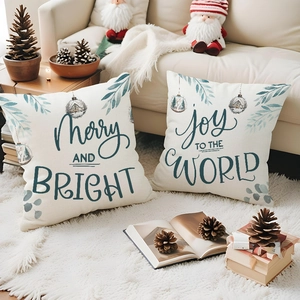 Close-up of linen Christmas pillow covers with holiday typography on a cozy rug