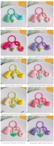 Macro detail of resin tulip keychains in vibrant colors with decorative tassels