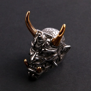 Detailed view of dual-tone Hannya mask ring in silver and gold stainless steel