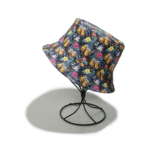 Detail of dark blue bucket hat with tropical beer and hibiscus floral prints