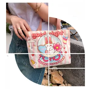 Detail of pink striped canvas handbag with cute rabbit print and good night text