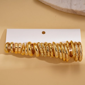 Set of 20 minimalist geometric gold hoop earrings displayed on elegant white carding