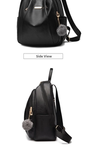 Side view detail of black leather backpack with gold zipper and gray plush charm