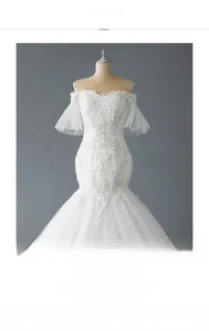 Detail of off-shoulder mermaid wedding dress with embroidery and sparkling sequins