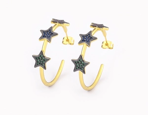 Detail of 18k gold plated C-shaped earrings with colorful zircon star charms