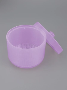 Detail view of purple translucent nail tool sterilization box with removable strainer basket