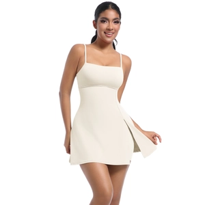 Detail view of cream-colored tennis dress with thin straps and side slit design