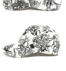 Detail of floral pattern on a black and white baseball cap with leather-like texture