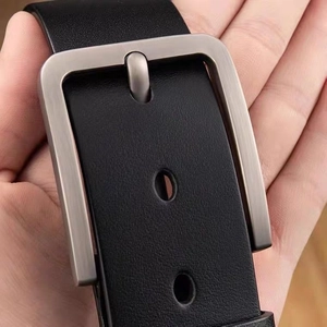 Men's casual black leather belt with rectangular brushed metal pin buckle shown in hand