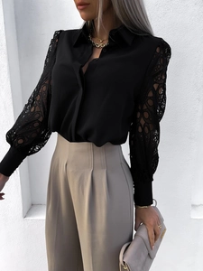 Detail of long sleeve black shirt featuring delicate lace patchwork and high waist pants