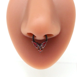Black bat septum ring with red wings and hanging heart gemstone on model