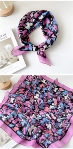 Detail view of purple cotton linen scarf featuring colorful butterfly patterns on white background