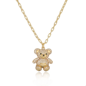 Detailed view of a golden bear necklace pendant fully set with sparkling white zircons
