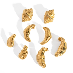 Detailed view of golden croissant shell earrings crafted in polished stainless steel