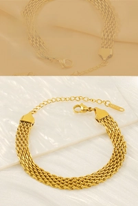 Detail of golden woven mesh chain bracelet with lobster clasp and adjustable extension link