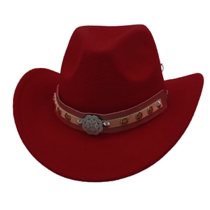 Macro shot of dark red felt cowboy hat with star studded leather band and floral buckle